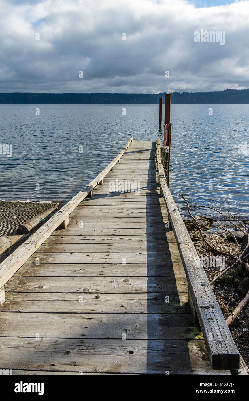 Wooden dock extending out into a lake. Stock Photo