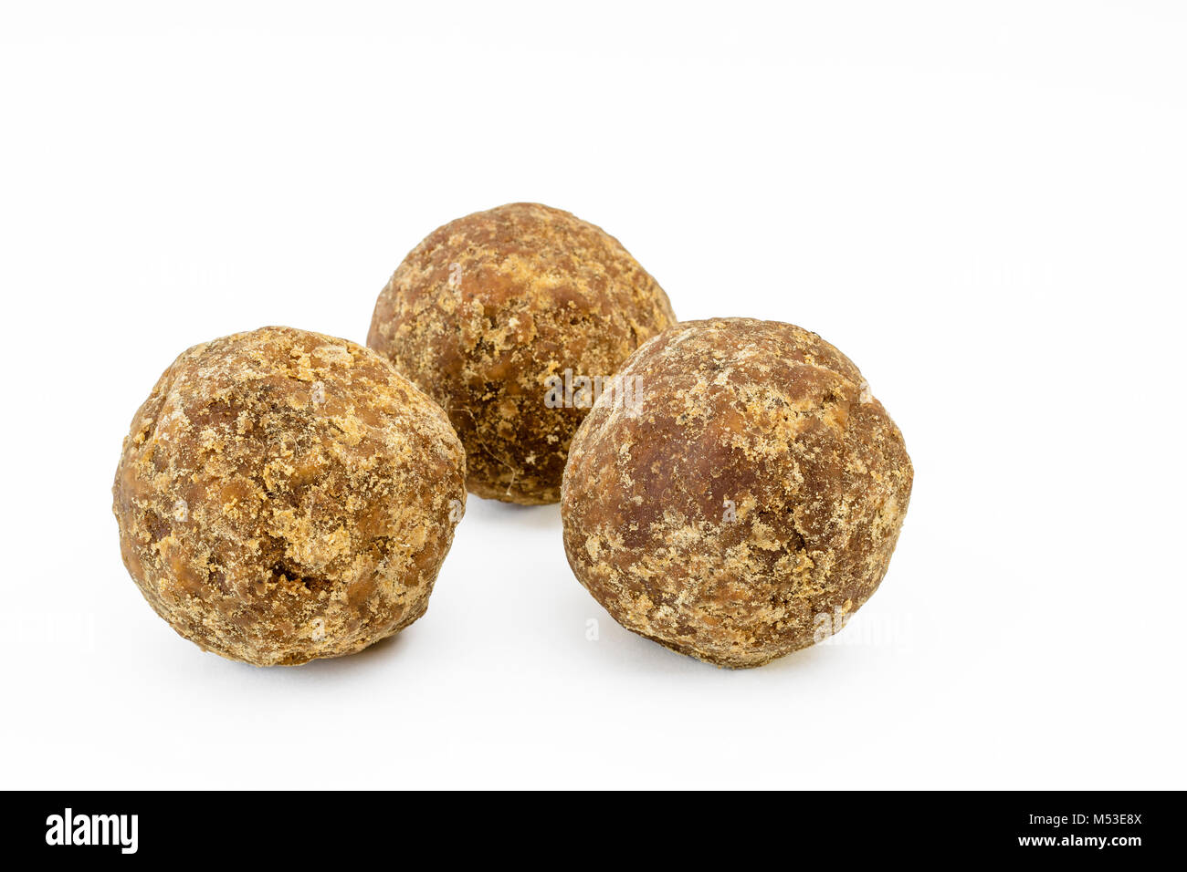 Indian palm sugar or jaggery on a white background Stock Photo