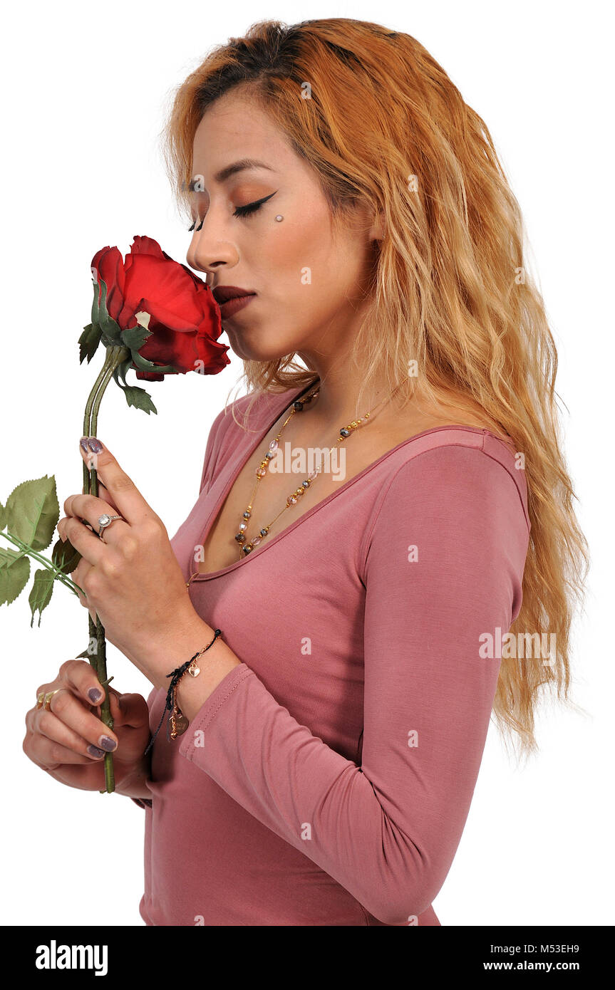 Beautiful woman smelling a fresh cut rose Stock Photo - Alamy