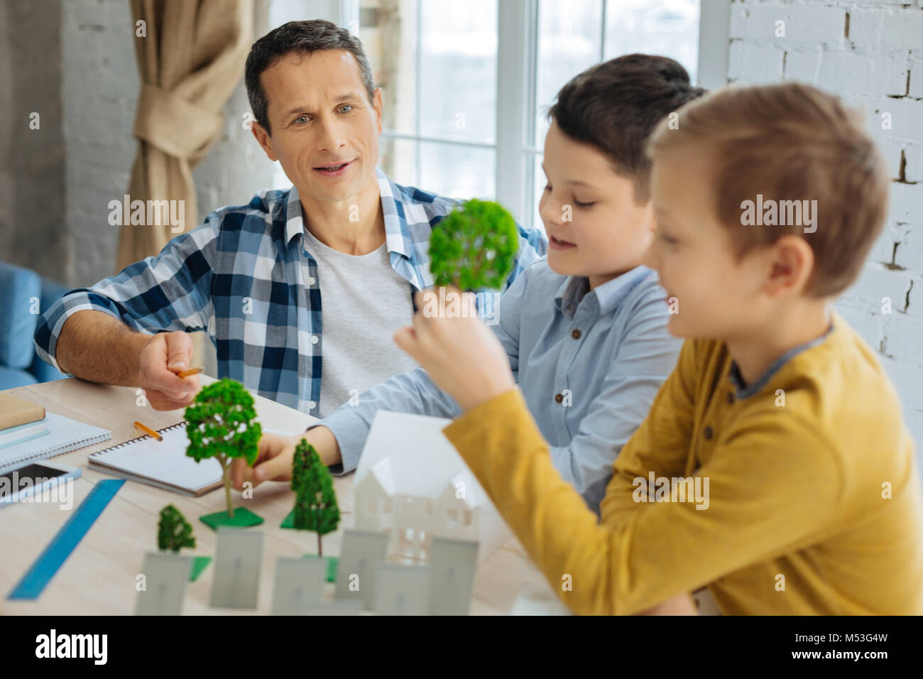 Young engineer telling his sons about landscape architecture Stock