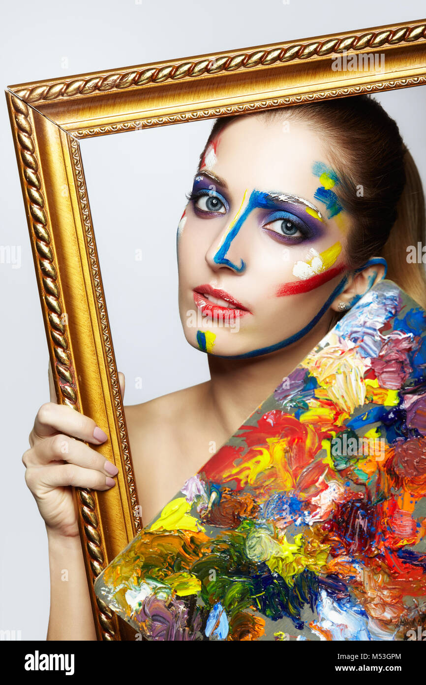 Young woman painter in golden frame with color palette in hand Stock ...