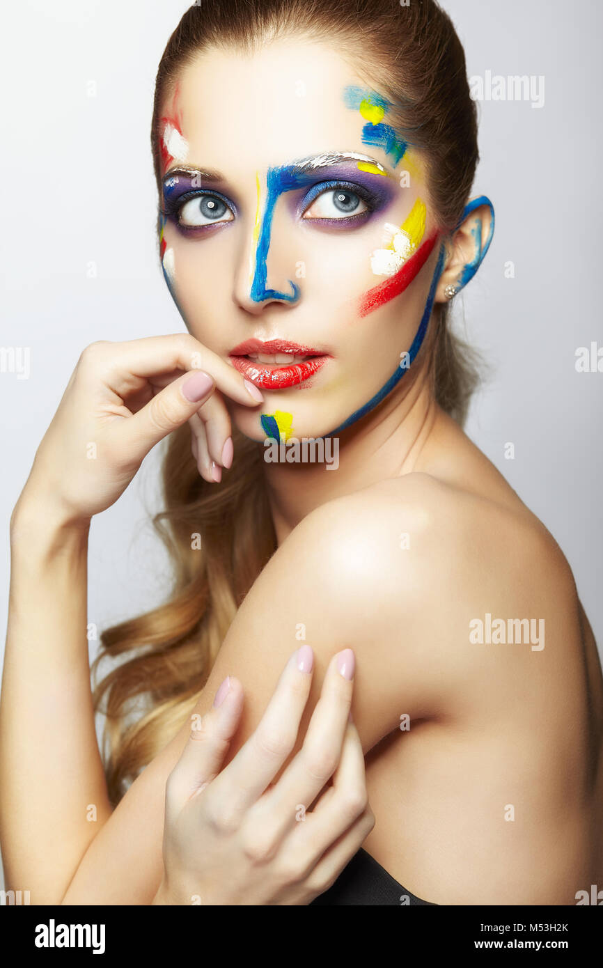 Young woman painter with acrylic paint on face Stock Photo Alamy