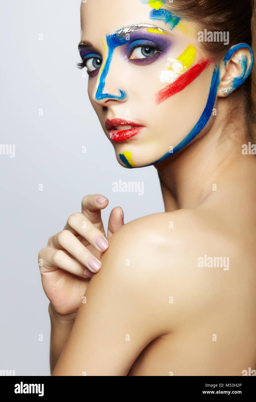 Young woman painter with acrylic paint on face Stock Photo - Alamy
