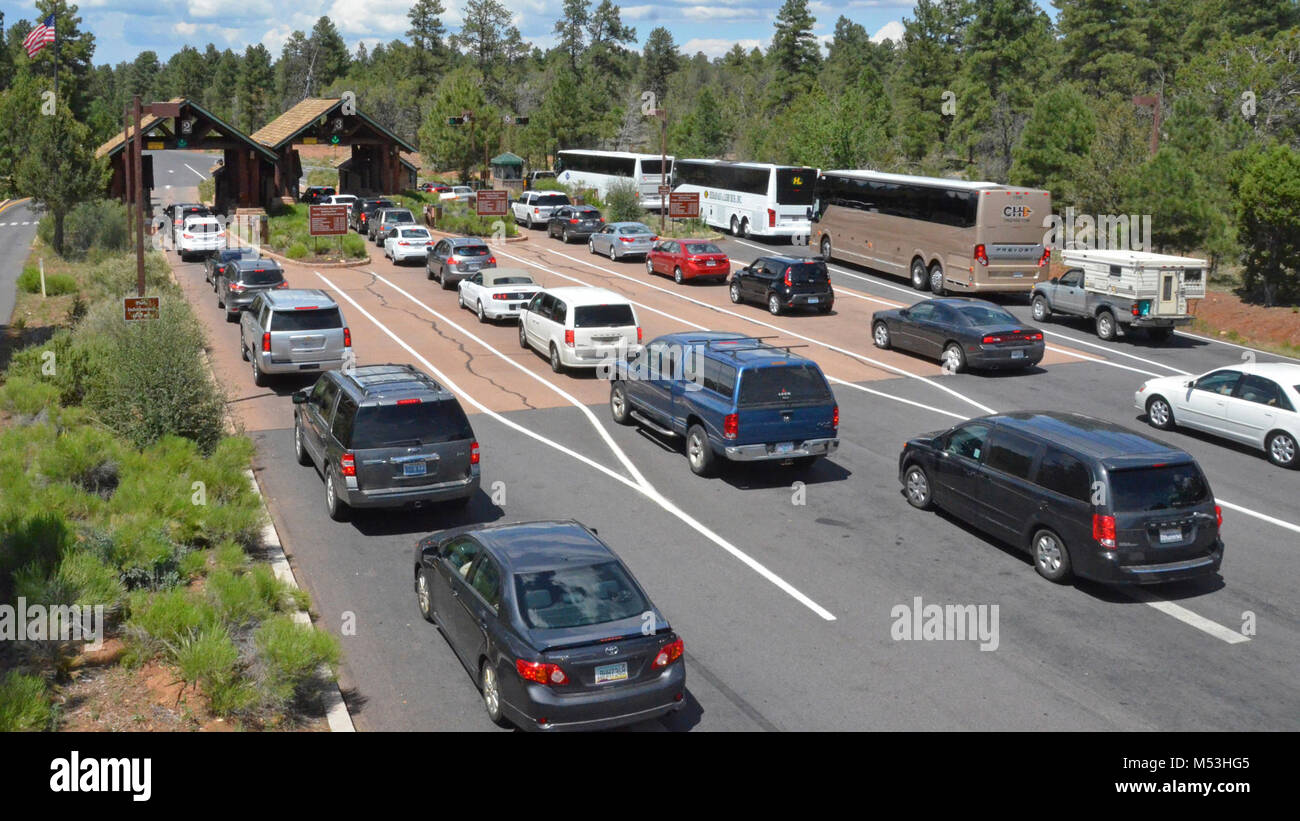 Grand Canyon National Park - South Entrance Line - July. Grand Canyon, Ariz. (June 29, 2015) Grand Canyon National Park has seen a 20 percent increase in visitation this year, compared to 2014. As a result, traffic regularly backs up at all entrance stations, with the longest wait time between 9 am and 4 pm. Waits during those times can last 30 minutes or more, particularly on weekends. Once in the park, visitors can also expect parking lots, especially at Grand Canyon Visitor Center, to start reaching capacity by 10 am.  Read more: go.nps.gov/f999sa Stock Photo