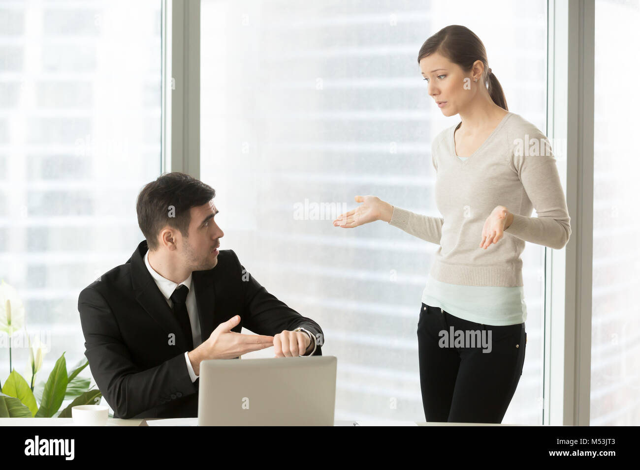 Woman explaining reason for being late for work Stock Photo