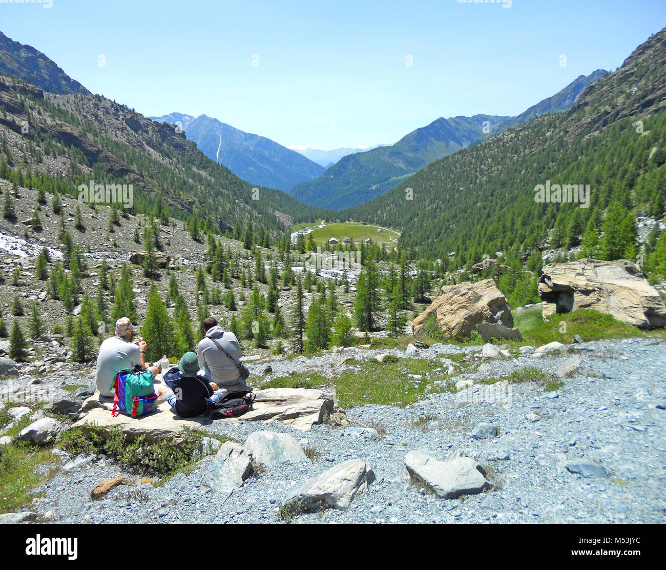 Wonderful view of a family with child having a good time and picnic in the mountain, on the Alps, Valle d'Aosta, Italy Stock Photo