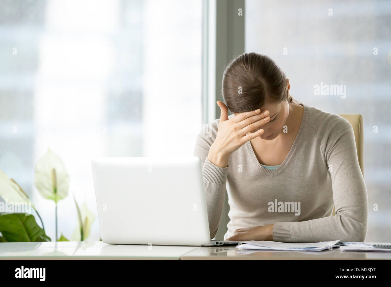 Tired female business leader suffering of migraine Stock Photo