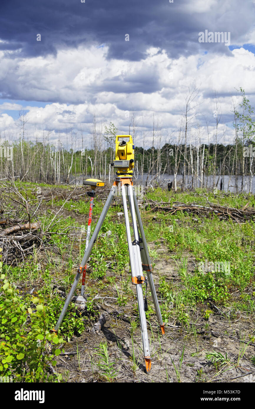 Worn an electronic total station and a GPS GLONASS receiver in the field in the forest Stock Photo