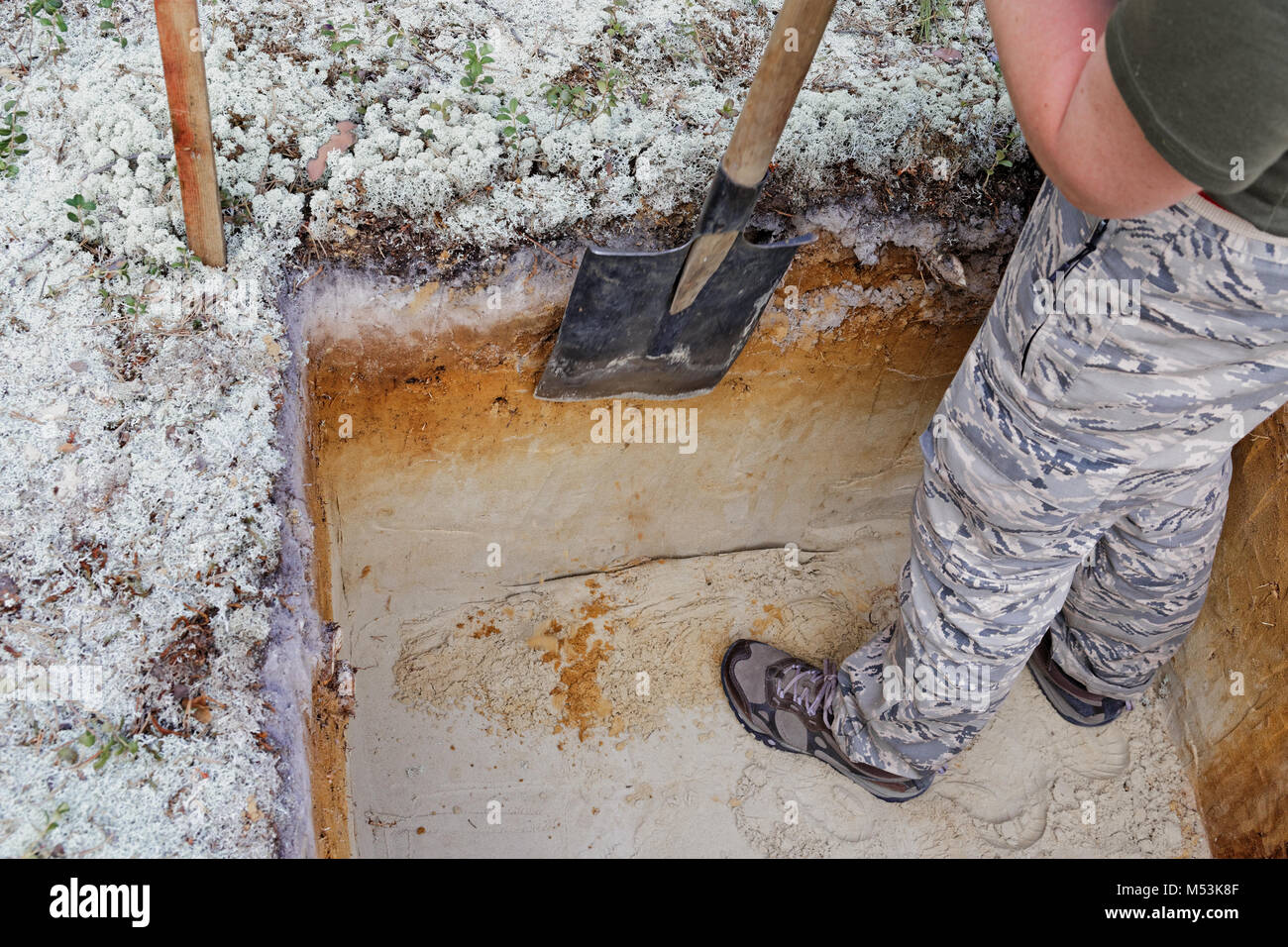 Archeology: leveling the excavation wall with a shovel Stock Photo