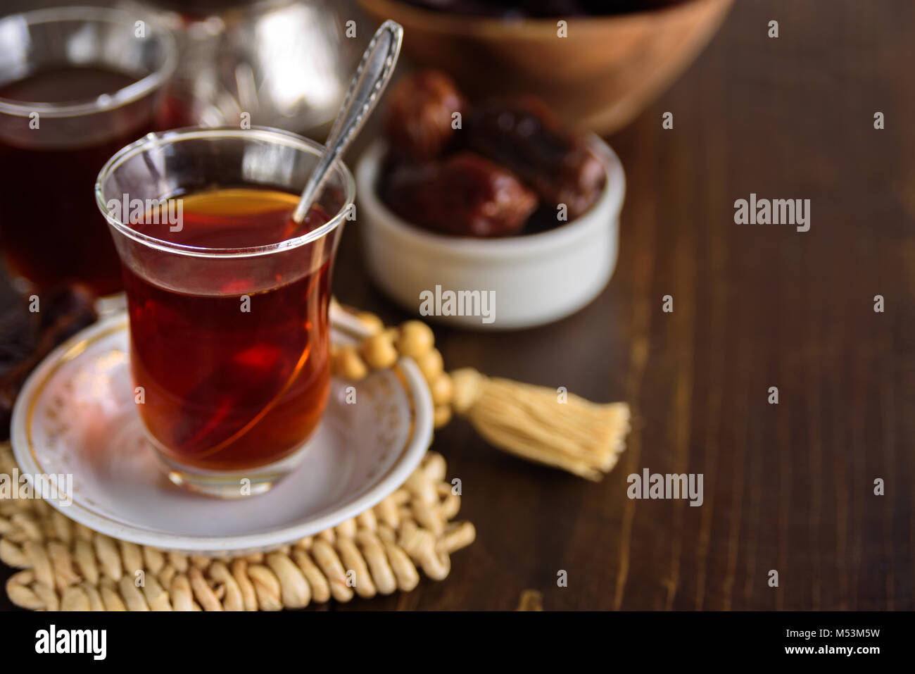 Dried dates fruits with tea for iftar. Prayer beads on background Stock Photo