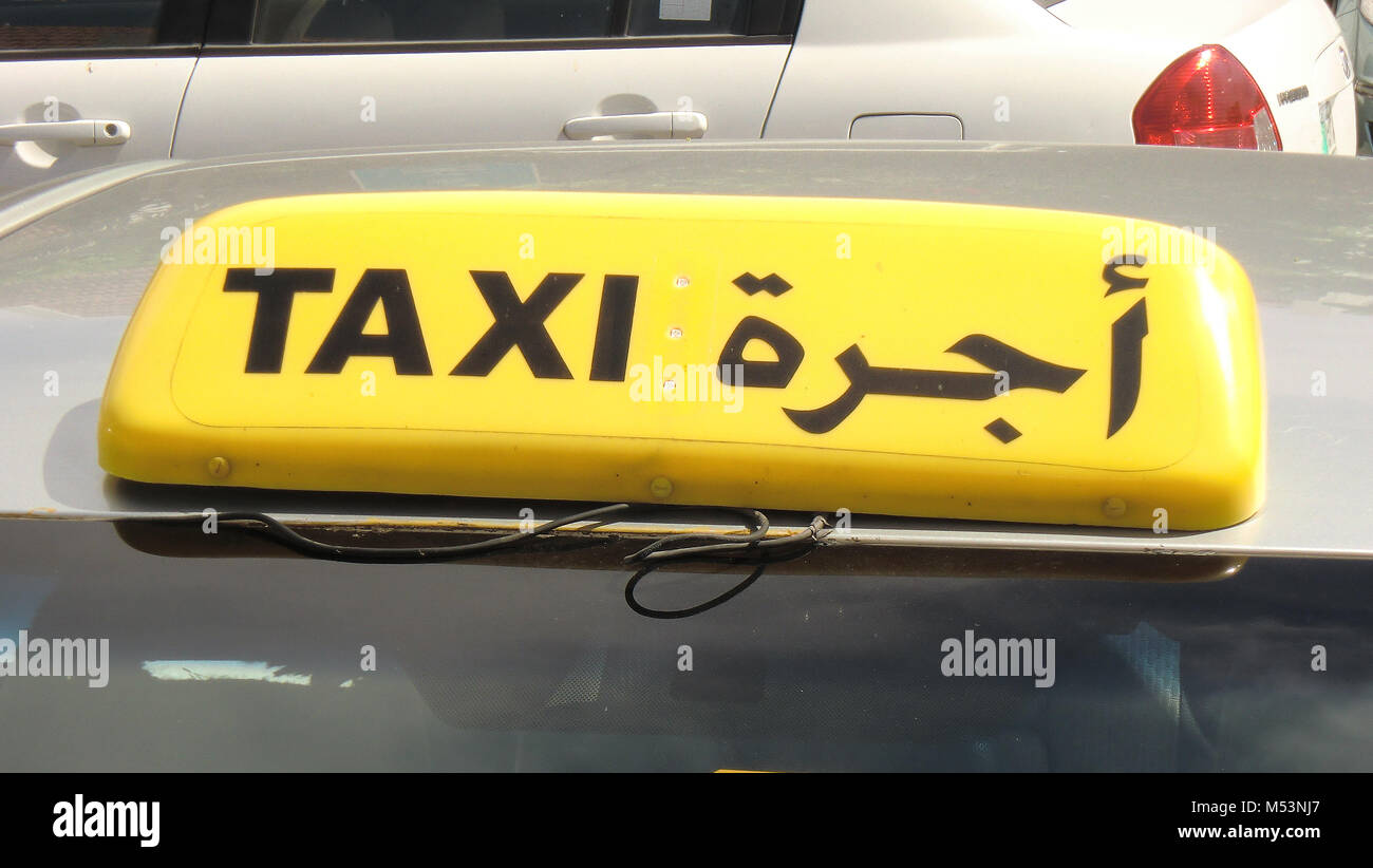 Taxi signs in English and Arabic in the Arabian Gulf Stock Photo