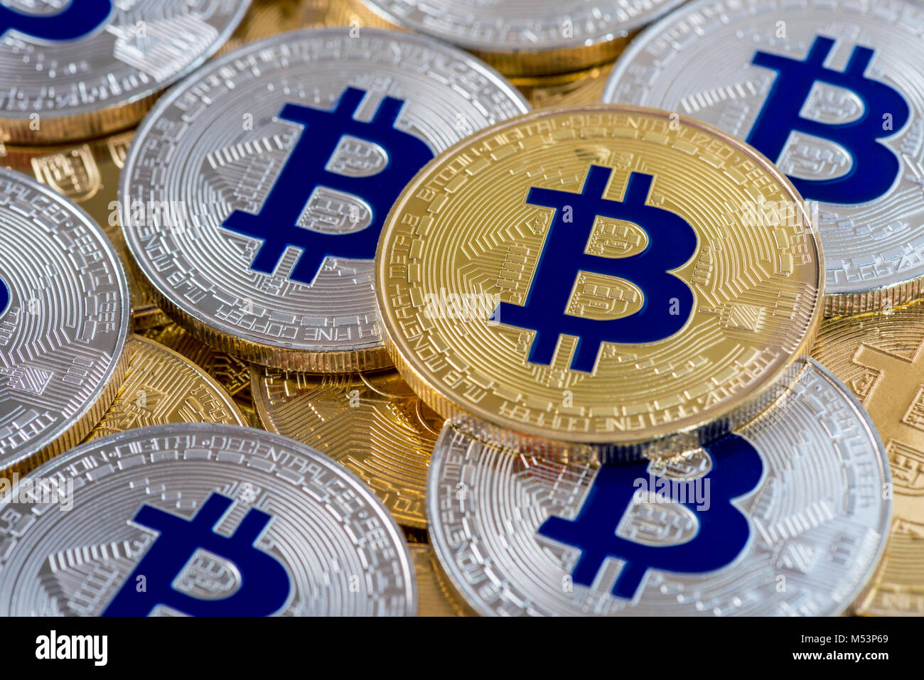 Layers of golden and silver colored Bitcoin coins, cryptocurrency background, investing in Bitcoins Stock Photo