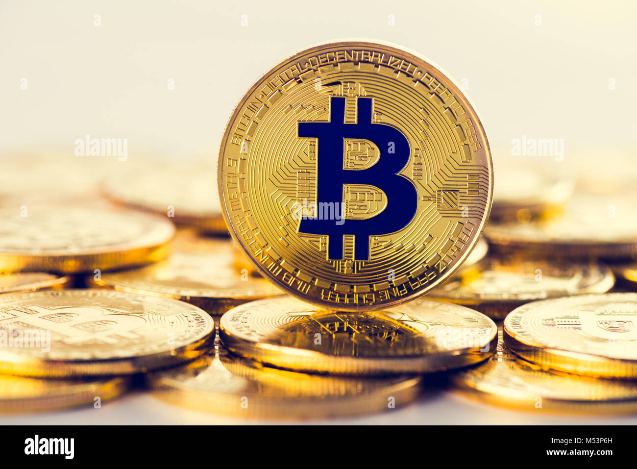 Front side of golden bitcoin coin on top of heap of another coins. Crypto  currency concept, gold colored image Stock Photo - Alamy