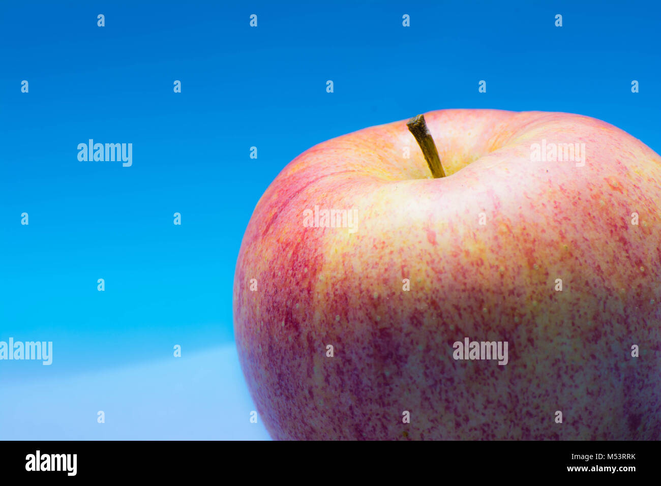 Apple Blue Background Stock Photo Alamy