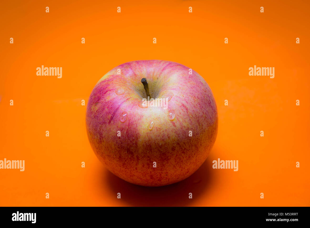 Apple Yellow Background Stock Photo - Alamy