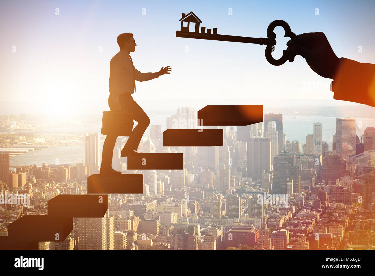 Businessman holding key in real estate concept Stock Photo - Alamy