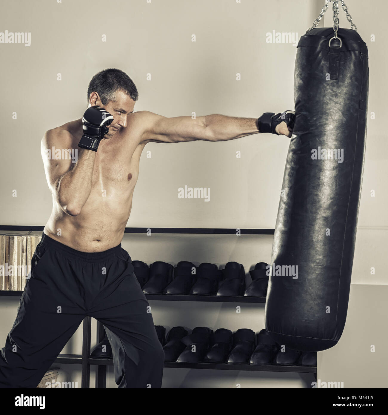 a middle age man at the punch bag Stock Photo