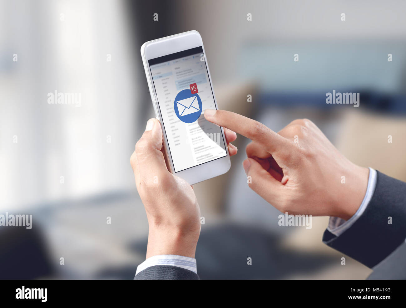 businessman hand touch email envelope icon on mobile screen Stock Photo