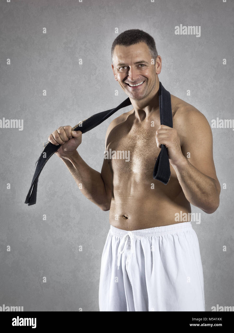 middle age martial arts sports man with a black belt Stock Photo