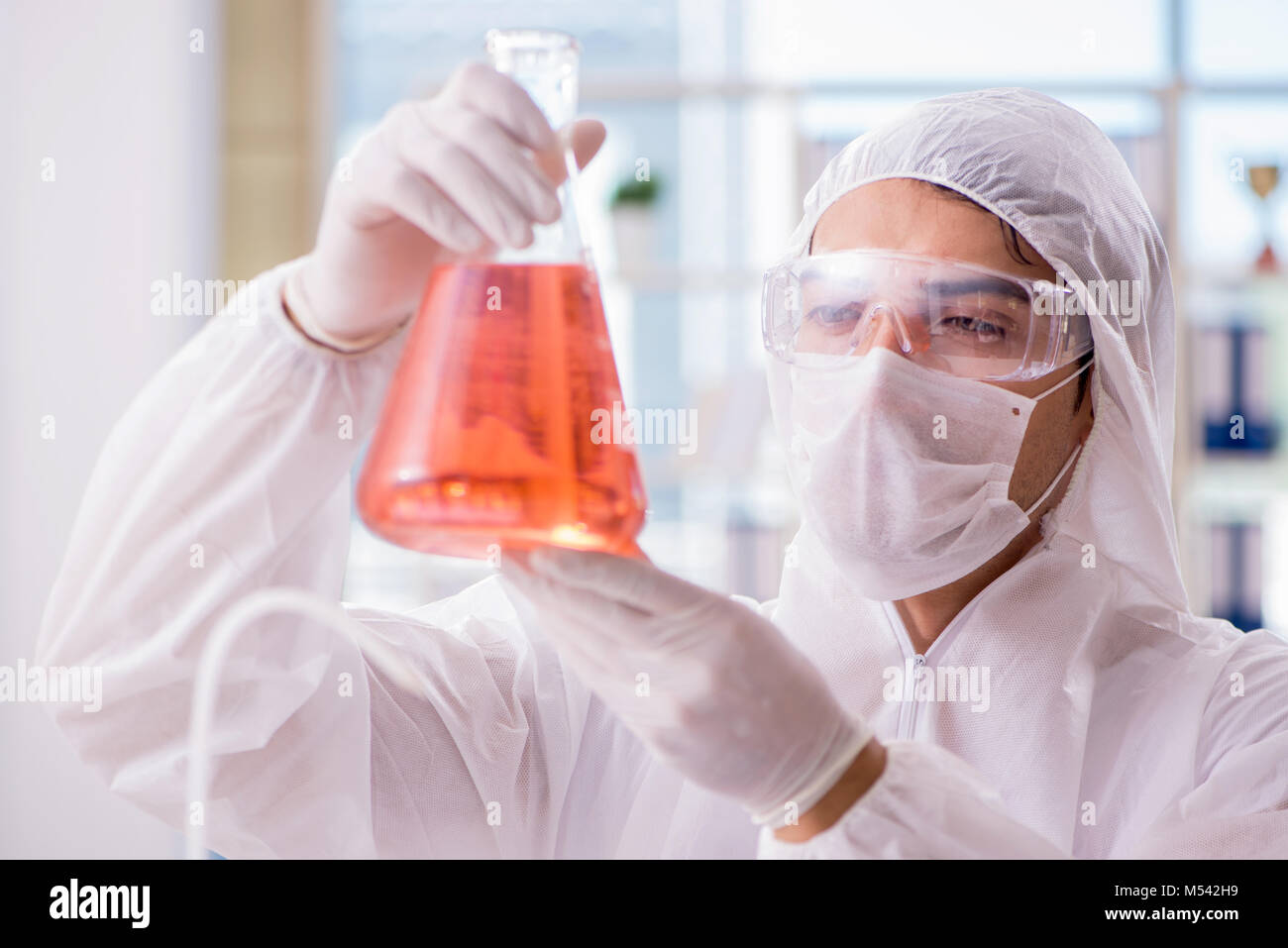 Chemist working in the laboratory with hazardous chemicals Stock Photo