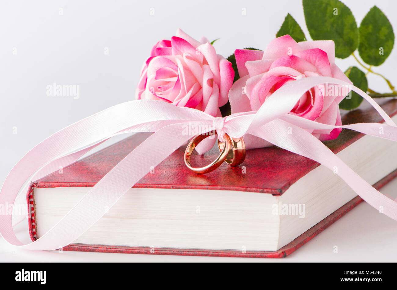 Wedding concept with rings and roses Stock Photo - Alamy