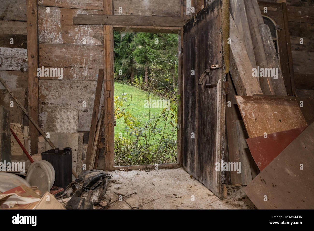 Old wooden door at an abandoned house - Lost Place Stock Photo