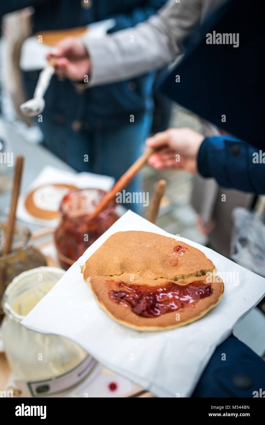 Adding jam to pancake Stock Photo Alamy