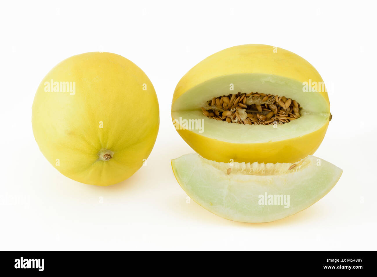 Sliced and whole golden honeydew melon on a white background Stock Photo