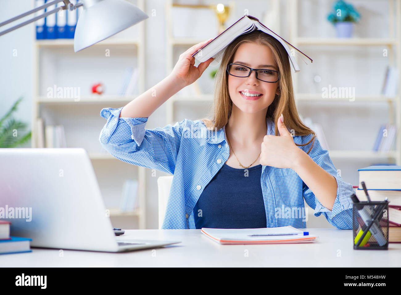 Young teenage female student preparing for exams at home Stock Photo ...