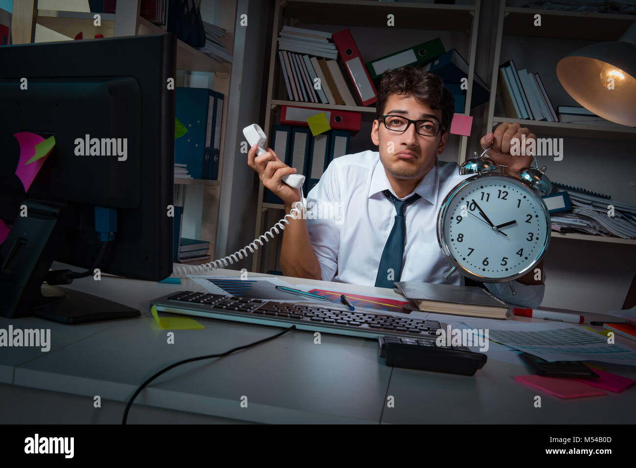 Man businessman working late hours in the office Stock Photo Alamy