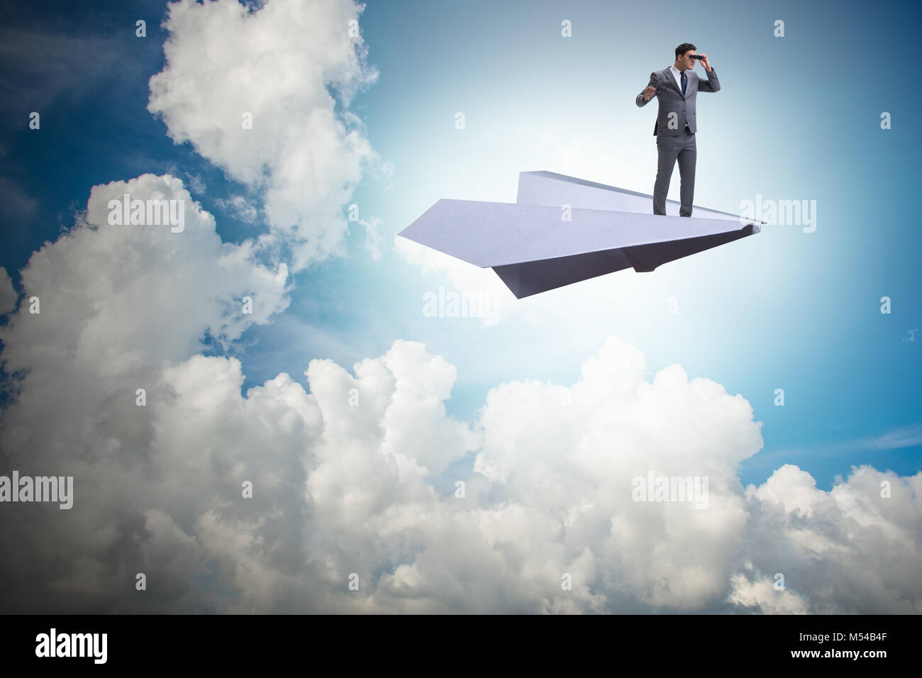 Businessman flying on paper plane in business concept Stock Photo - Alamy