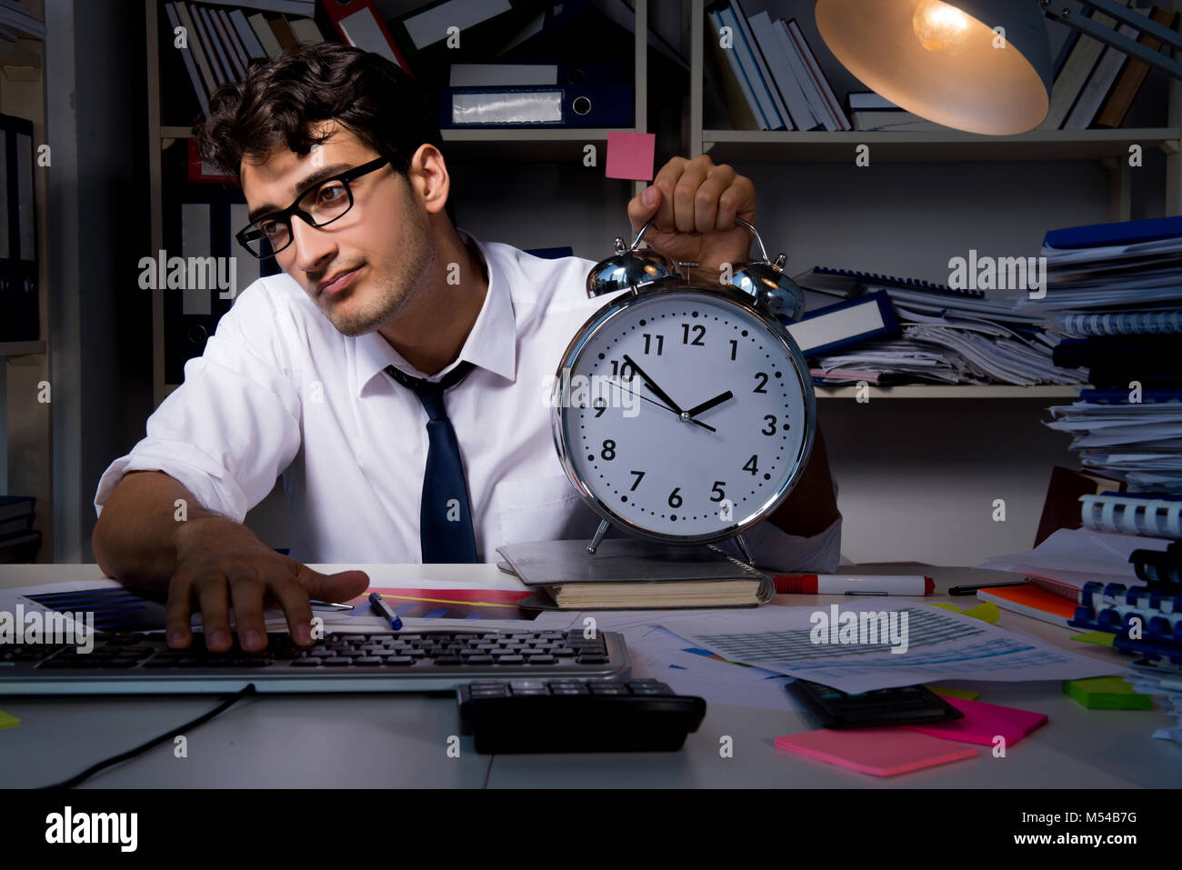 Man businessman working late hours in the office Stock Photo Alamy
