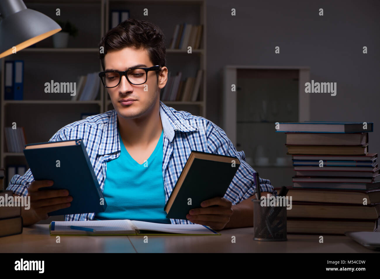 Student preparing for exams late night at home Stock Photo - Alamy