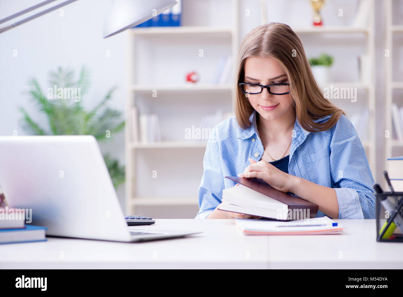 Young teenage female student preparing for exams at home Stock Photo ...