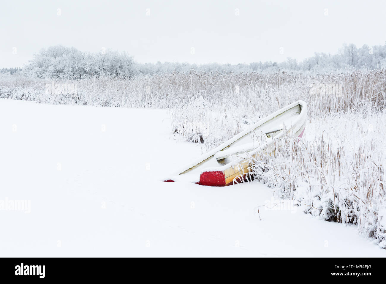 Winter landscape with a row boat on the beach Stock Photo