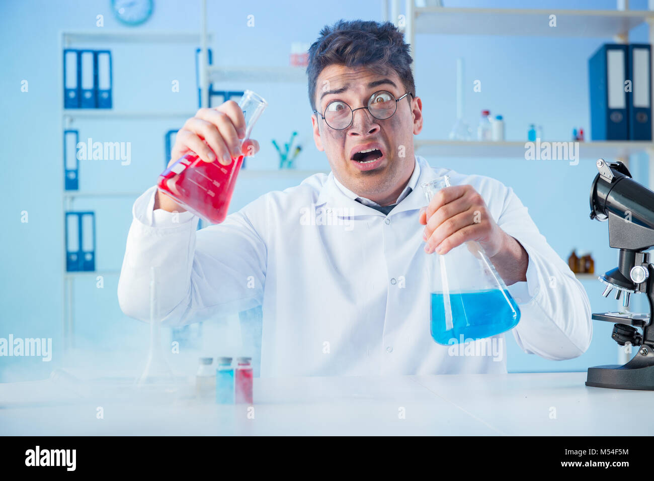 Funny mad chemist working in a laboratory Stock Photo