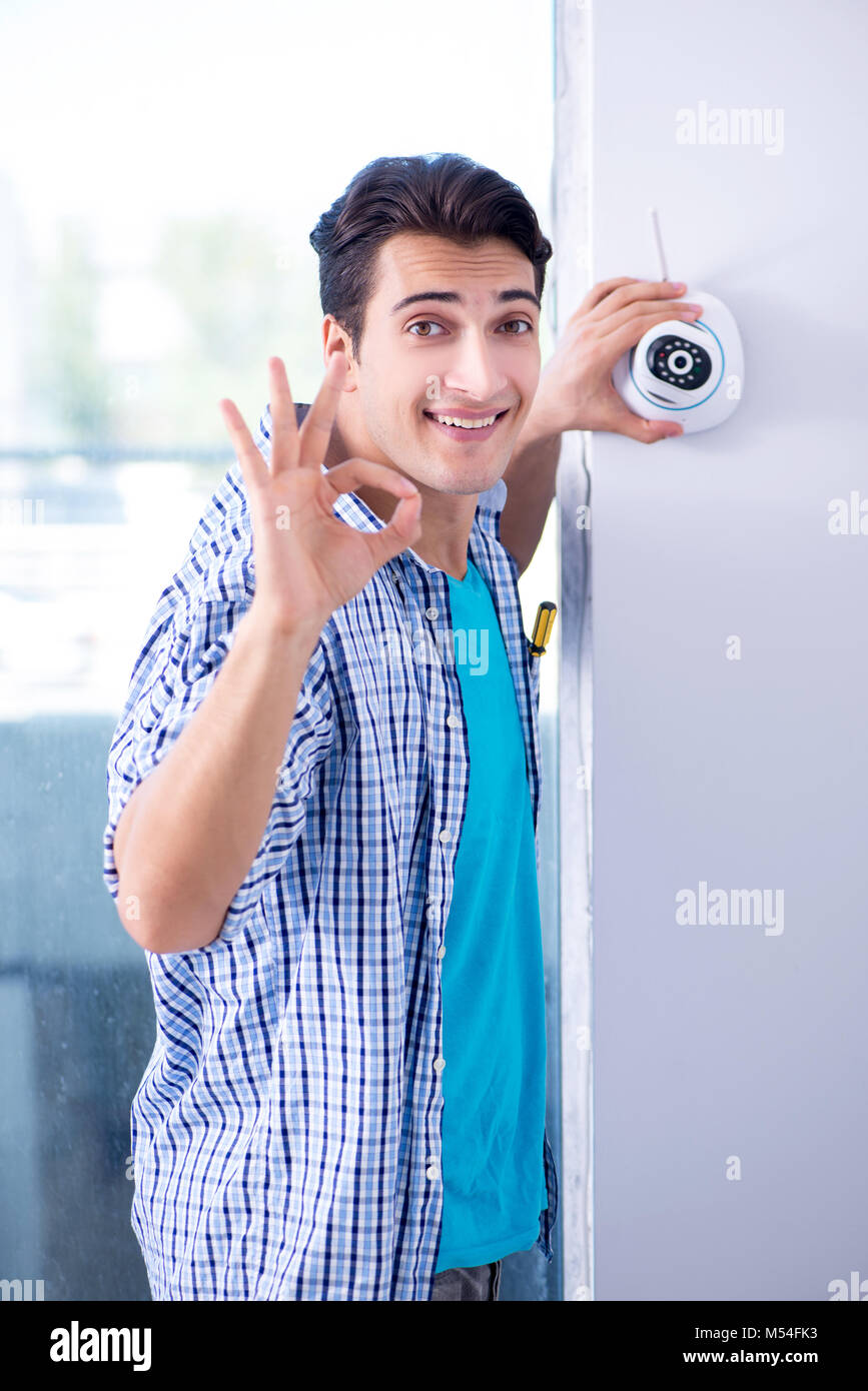 Man installing surveillance CCTV cameras at home Stock Photo Alamy