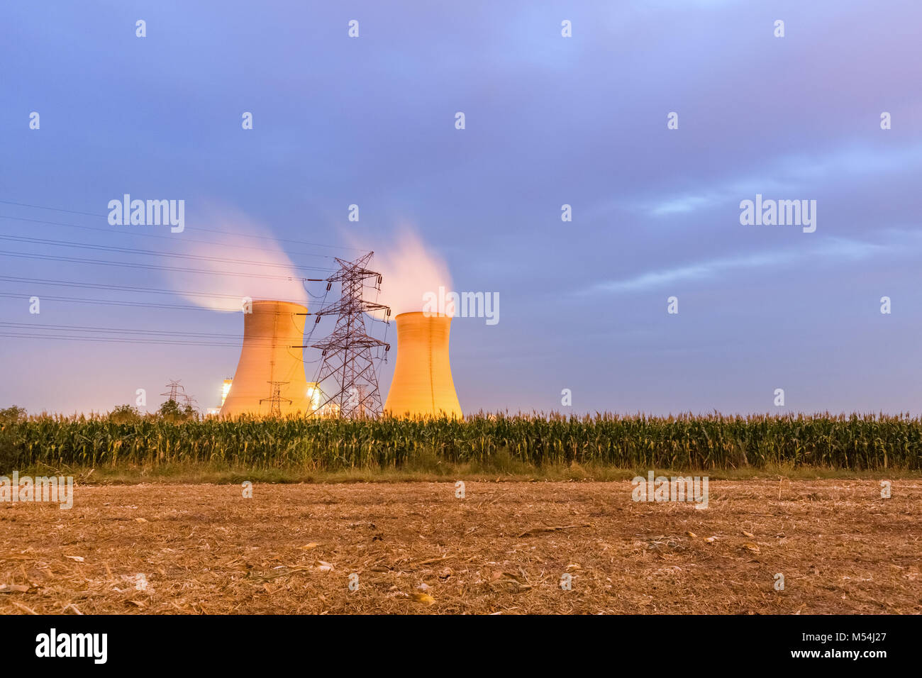 power plant on farmland at night Stock Photo