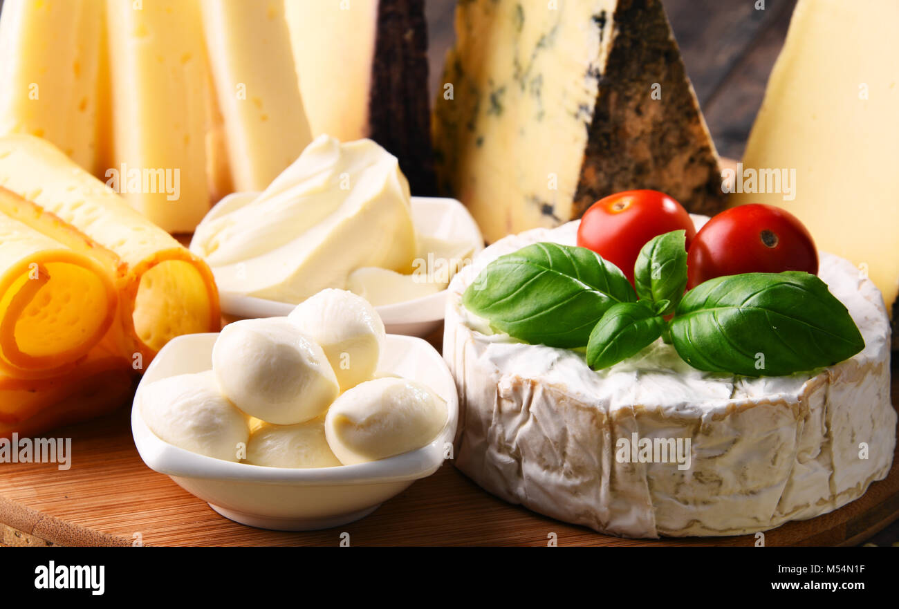Different sorts of cheese on kitchen table Stock Photo - Alamy