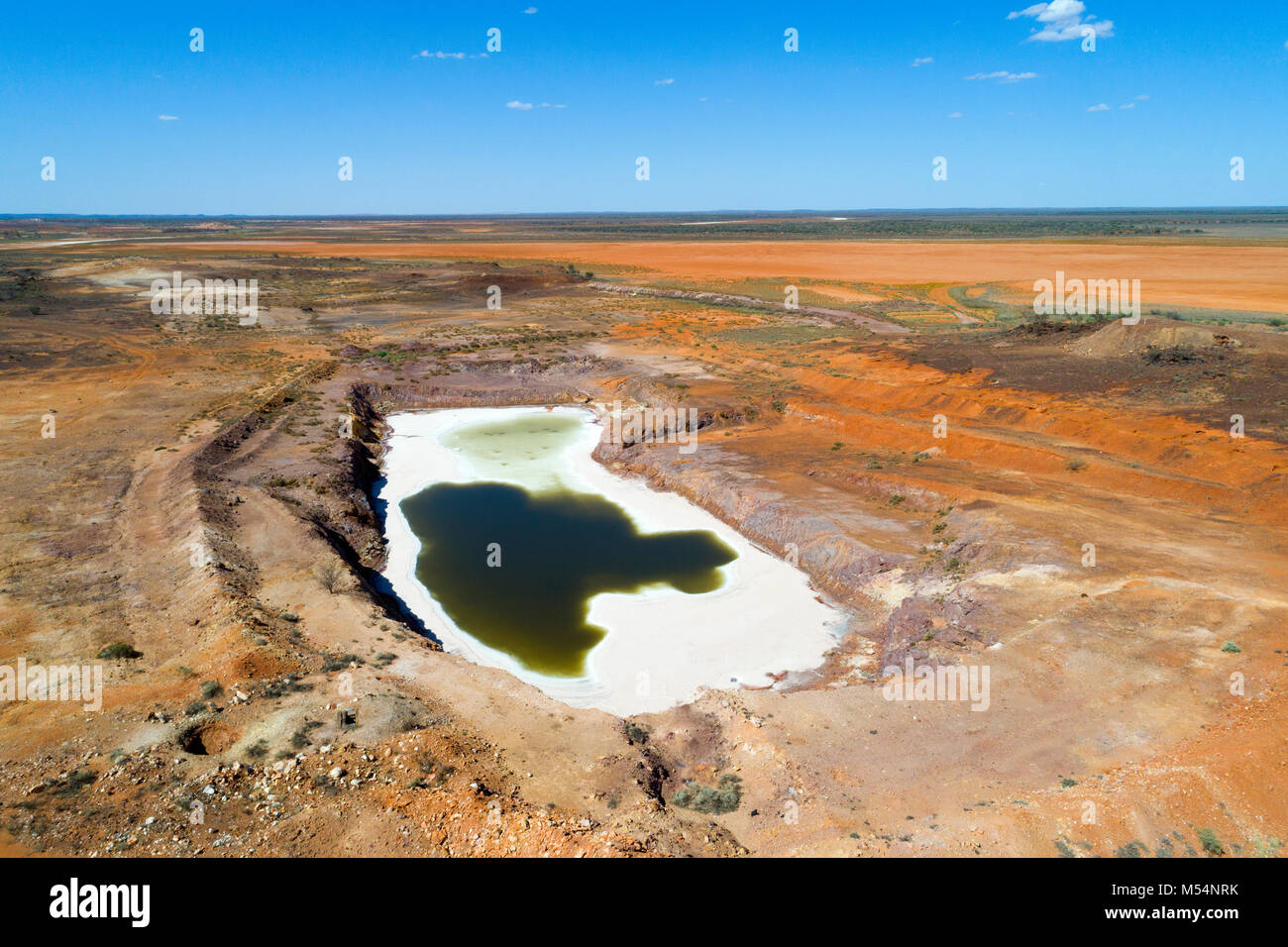 Aerial view of abandoned open cut gold mine that has filled with water turning to salt,, Meekathara, Murchison, Western Australia Stock Photo