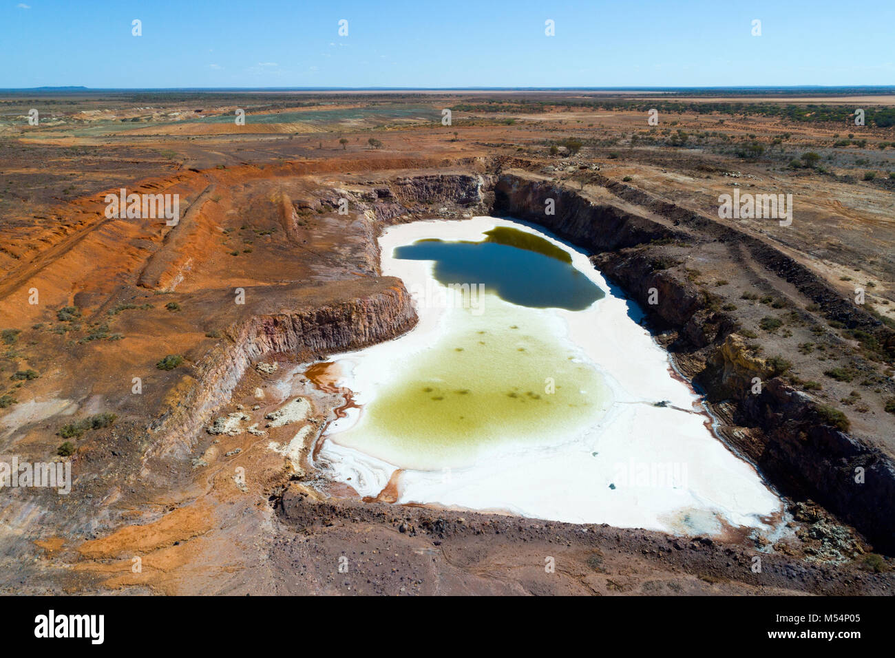 Aerial view of abandoned open cut gold mine that has filled with water turning to salt,, Meekathara, Murchison, Western Australia Stock Photo