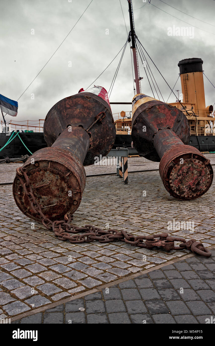 The buoys have been raised on the ground at the Lennusadama area in Tallinn, Estonia. You can see the old tugboat Suur Töll in the background. Stock Photo