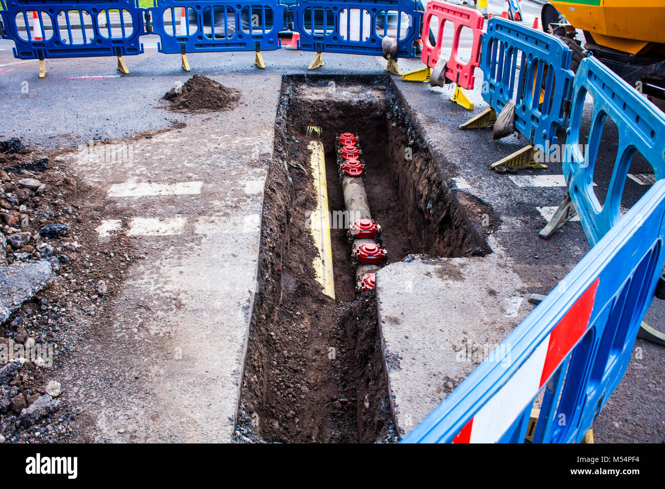 Installing new pipes in city street, maintenance work, dig, reparation