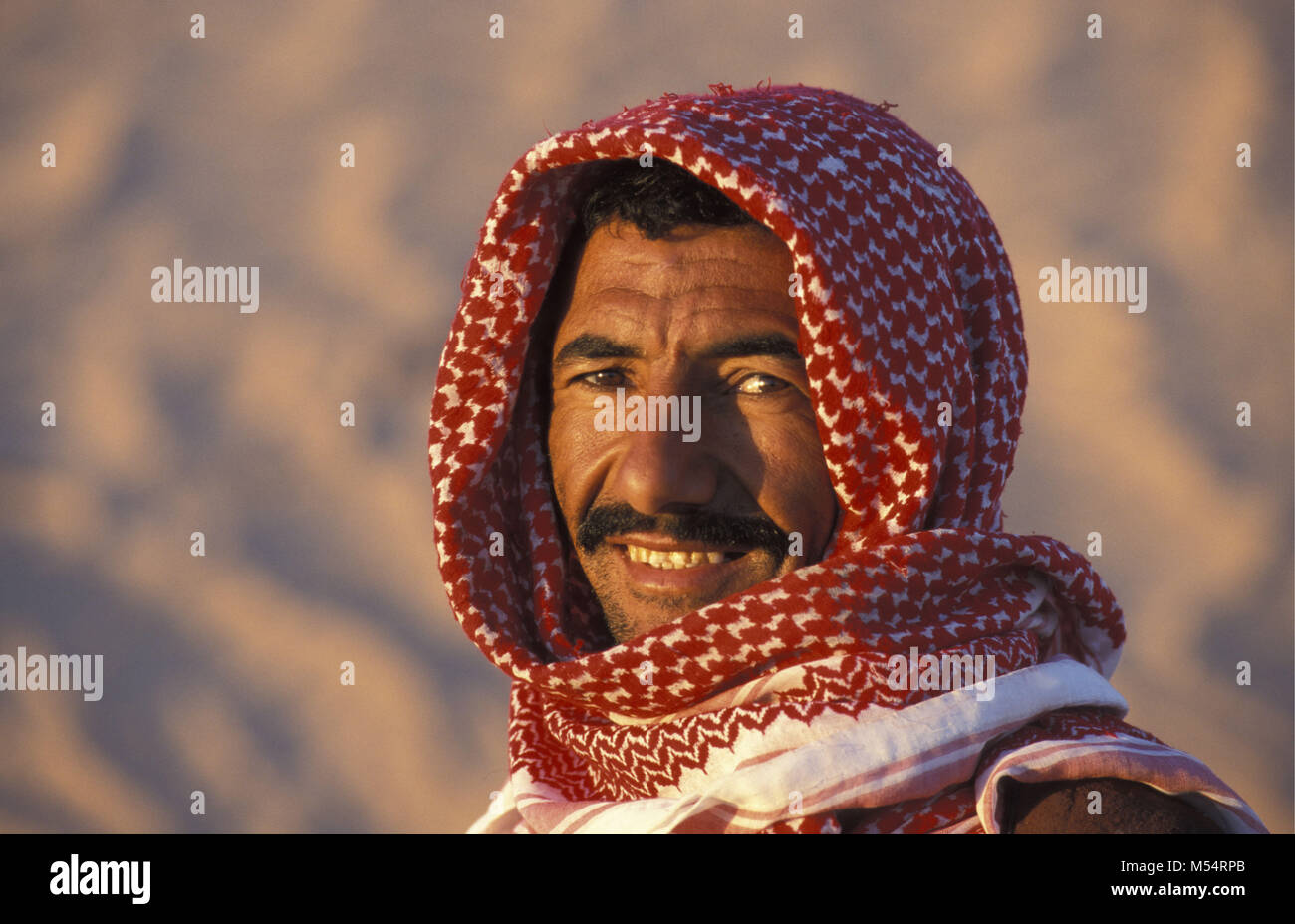 Algeria. Near Touggourt. The Eastern Sand Sea. Grand Erg Oriental. Sahara desert. Portrait of Bedouin man. Stock Photo
