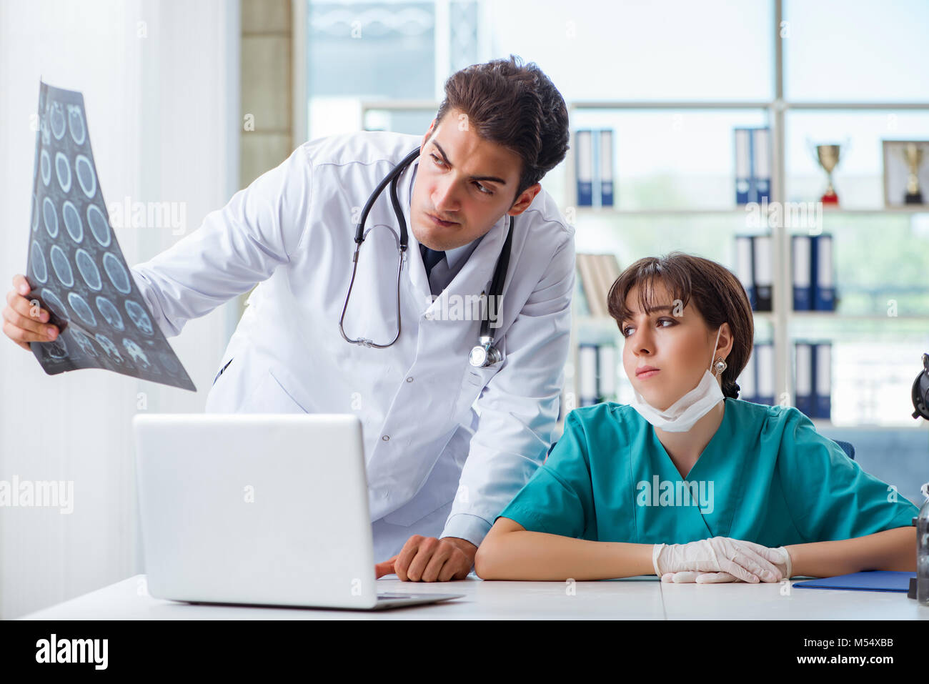 Two Physicians The two doctors discussing x-ray mri image in hospital Stock Photo - Alamy