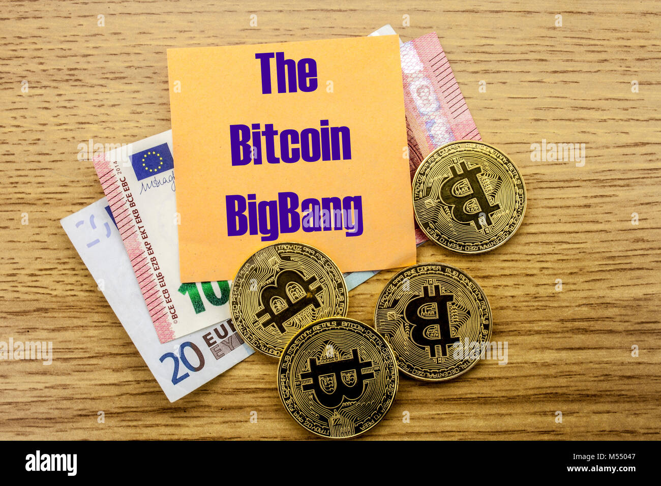 Bitcoins, Bit Coin on Euro, Dollars notes witch sticky note on wooden background,THE BITCOIN BIGBANG bitcoin concept. Stock Photo
