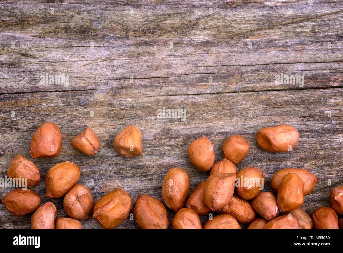 Shelled peanuts (Arachis hypogaea), legumes used for human consumption and animal feed. Stock Photo