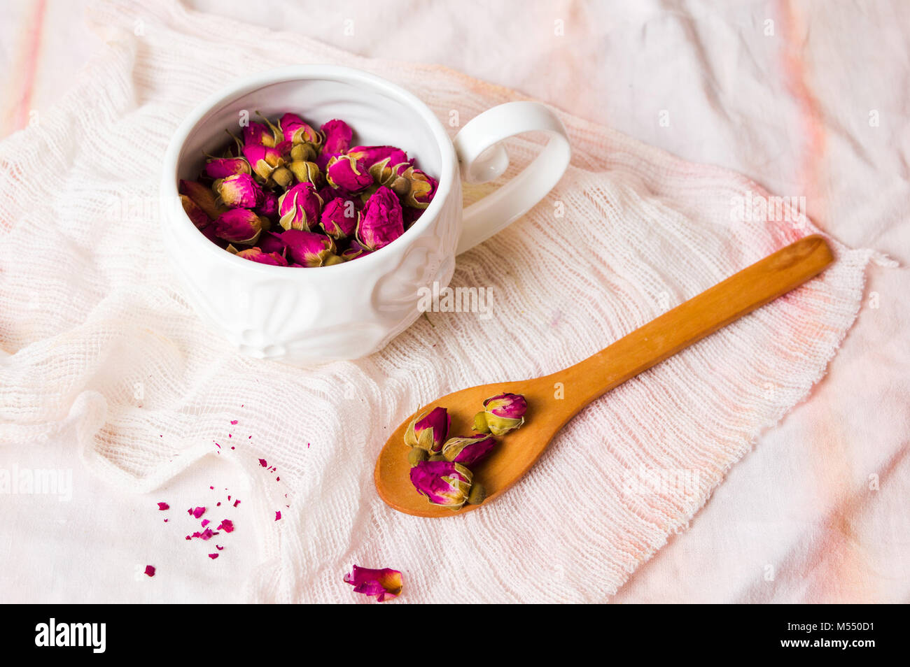 Rose tea buds in a white tea cup Stock Photo Alamy