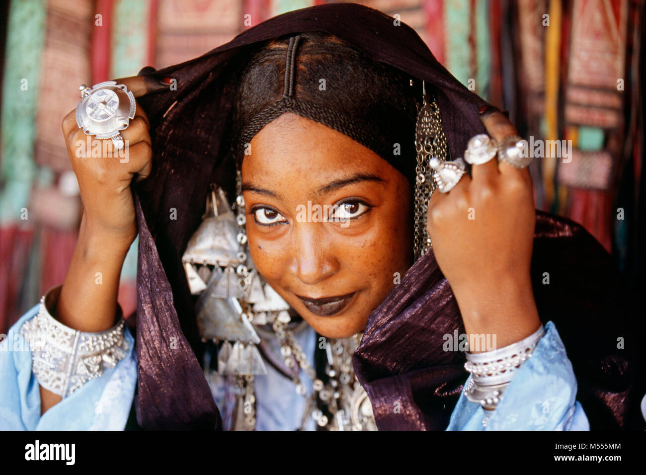 Algeria. Tamanrasset. Sahara desert. Portrait veiled woman of Tuareg tribe during the TAFSIT or springfestival. Indigo blue headscarf. Stock Photo