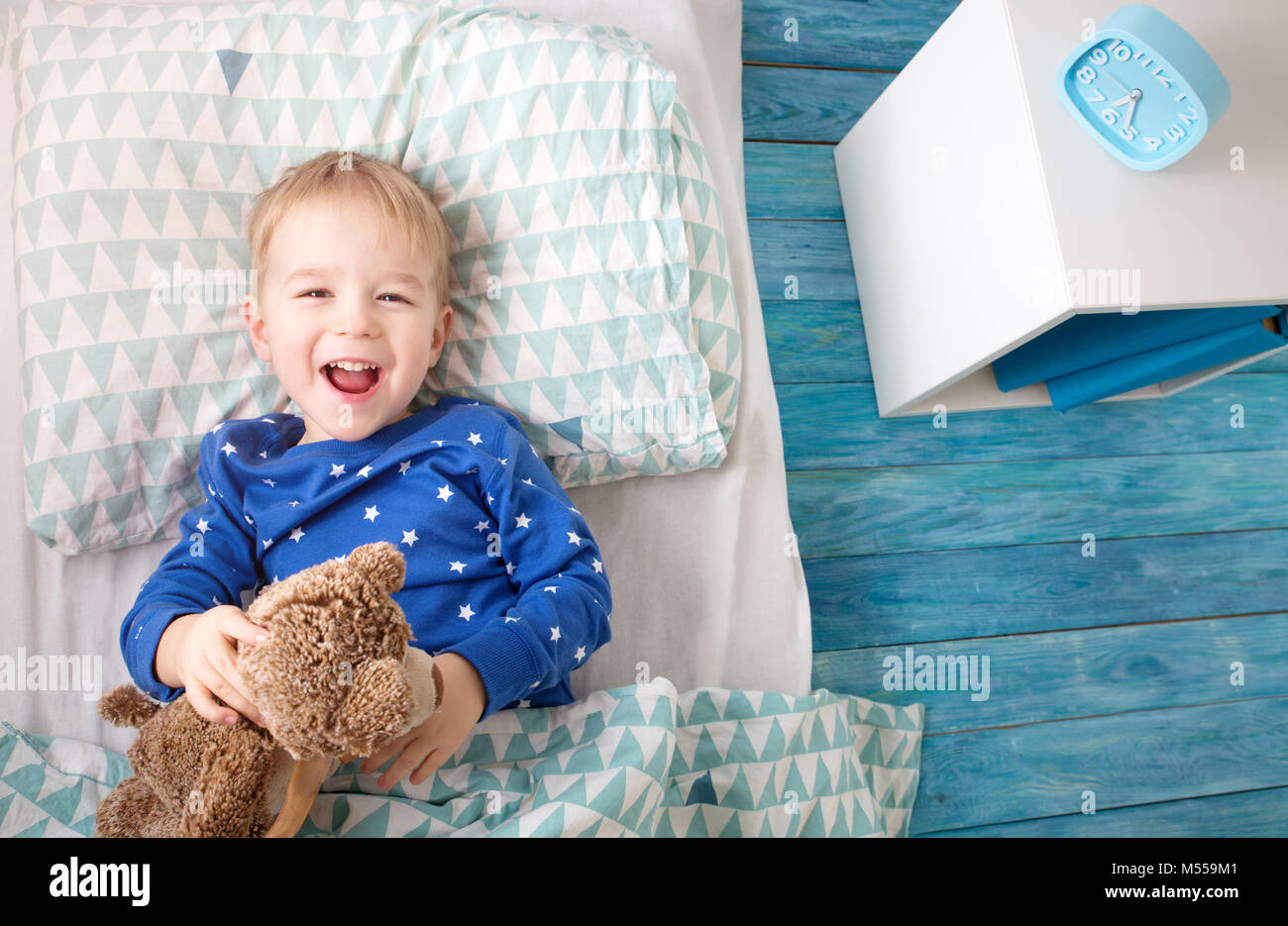 Three years old child lying in bed Stock Photo Alamy